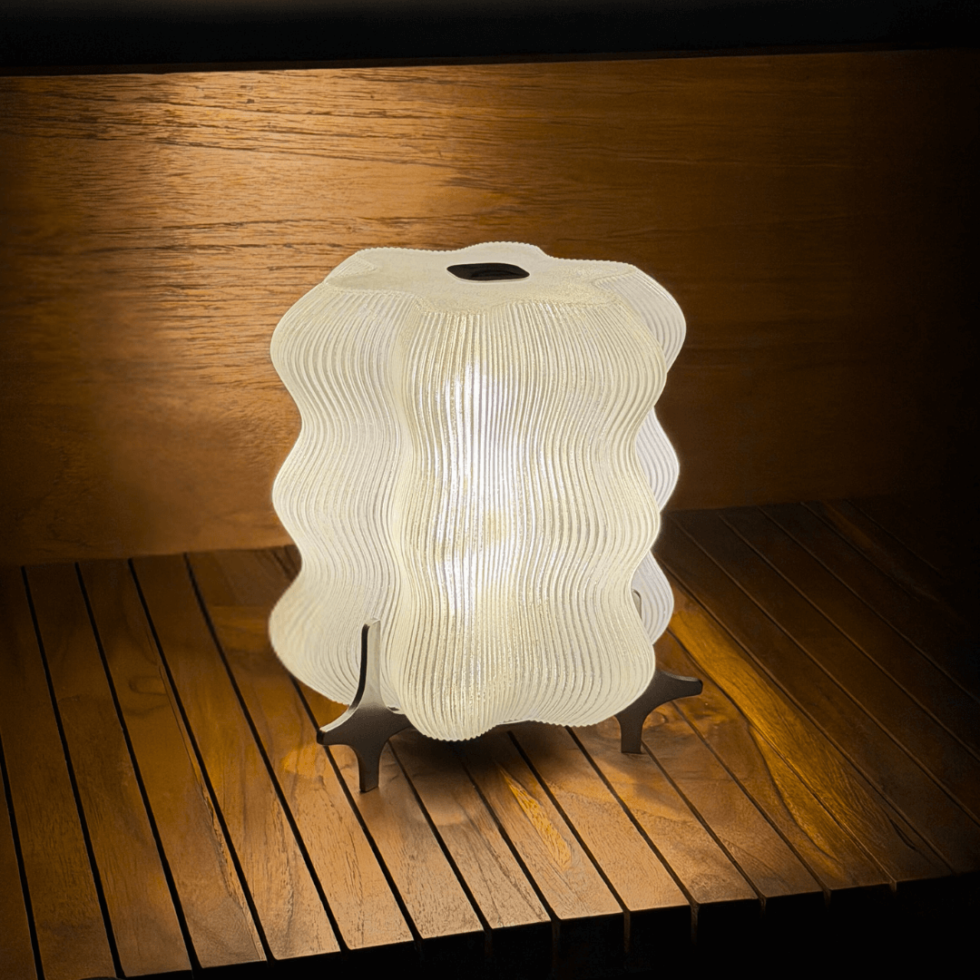 AURA modern table lamp styled beside a bed for soft evening light