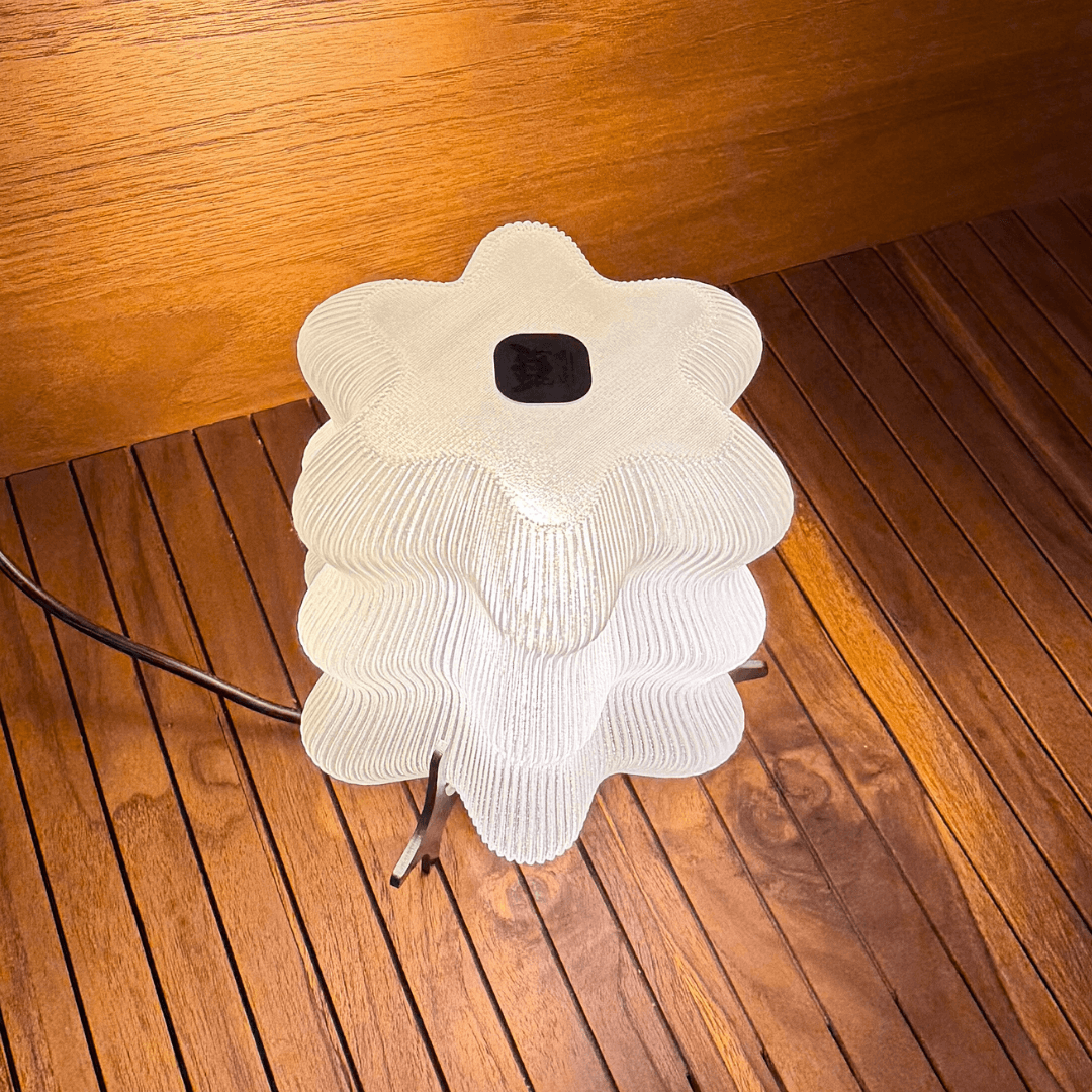 AURA sculptural table lamp creating soft ambient light in modern interiors