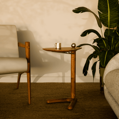 Modern wooden side table Trilo styled next to a sofa in a contemporary living room with warm neutral tones