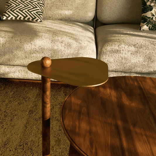 Close-up of Trilo accent table with triangular brass top and hand-turned ball detail.