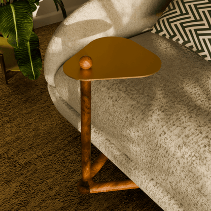 Trilo side table next to a modern sofa, showcasing solid teak wood and sculptural design